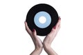 Female hand holds a 45 rpm vinyl record. Royalty Free Stock Photo