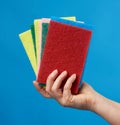 Female hand holds stack kitchen sponges for washing dishes