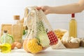 Female hand holds string bag with fresh food, concept of cooking Royalty Free Stock Photo