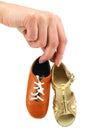 Female hand holds tiny dancing shoes Royalty Free Stock Photo