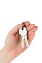 Female hand holds two keys isolated on white background Royalty Free Stock Photo