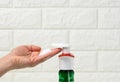 Female hand holds white foam squeezed out of a plastic dispenser, antiseptic, close up Royalty Free Stock Photo