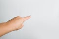 Female hand isolated on a white background showing a gesture, pointing a finger Royalty Free Stock Photo