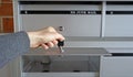 Female hand with keys, young woman opened her mailbox for new postage