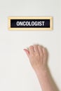 Female hand is knocking on Oncologist door