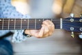 Female hand learning to play guitar