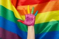 Female hand LGBT colors against LGBT flag