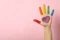 Female hand LGBT colors on pink background