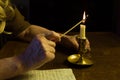 Lighting a vintage candle with a match Royalty Free Stock Photo