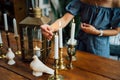 Female hand lights candles on wooden table. romantic dinner