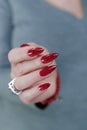 Female hand with long nails and a bright red manicure Royalty Free Stock Photo