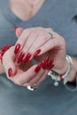 Female hand with long nails and a bright red manicure Royalty Free Stock Photo