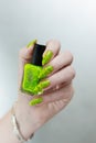 Female hand with long nails and a bright yellow green neon manicure Royalty Free Stock Photo