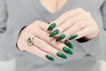 Female hand with long nails and green manicure Royalty Free Stock Photo