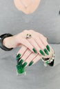 Female hand with long nails and green manicure Royalty Free Stock Photo