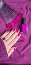 Female hand with long nails holds a bottle nail polish Royalty Free Stock Photo