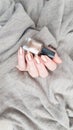 Female hand with long nails holds a bottle nail polish Royalty Free Stock Photo