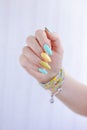 Female hand with long nails and multi-colored bright bottle manicure with nail polish Royalty Free Stock Photo