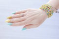 Female hand with long nails and multi-colored bright bottle manicure with nail polish Royalty Free Stock Photo