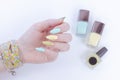 Female hand with long nails and multi-colored bright bottle manicure with nail polish Royalty Free Stock Photo