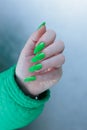 Female hand with long nails and neon green manicure Royalty Free Stock Photo