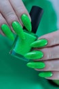 Female hand with long nails and neon green manicure Royalty Free Stock Photo