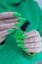 Female hand with long nails and neon green manicure Royalty Free Stock Photo