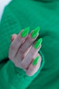 Female hand with long nails and neon green manicure Royalty Free Stock Photo