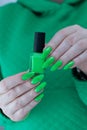 Female hand with long nails and neon green manicure Royalty Free Stock Photo