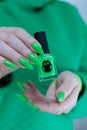 Female hand with long nails and neon green manicure Royalty Free Stock Photo