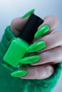 Female hand with long nails and neon green manicure Royalty Free Stock Photo