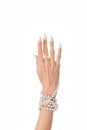 Female hand with long white nails wearing a pearl bracelet isolated on a white background Royalty Free Stock Photo