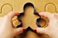 Female hand making christmas gingerbread men cookies Royalty Free Stock Photo
