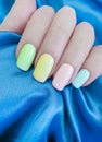 Female hand manicure colored elegance silk fabric