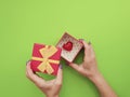 Female hand manicure, gift box, heart on colored background