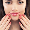 Female hand with manicured nails. Pink lips makeup and pink nailpolish, beauty manicure concept Royalty Free Stock Photo
