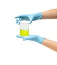 Female hand in a blue rubber glove hold a green medicine on a white background isolate Royalty Free Stock Photo