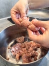 Female hand mixing minced meat in bowl on kitchen, close-up