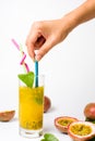 Female mixing passion fruit juice with a spoon Royalty Free Stock Photo