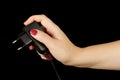 Female hand with mobile phone charger isolated on the black background Royalty Free Stock Photo