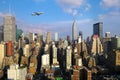 Female hand with mobile phone take picture of midtown of Manhattan. Plane flies over skyscrapers of New York City, Manha