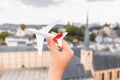 hand with a model aircraft on the background of the sights of Luxembourg. Concept of airline and air transport