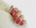 Female hand nails manicure red sweater Royalty Free Stock Photo