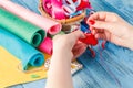 Female hand with needlework objects on blue wood table