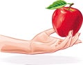 Female hand offering an apple.