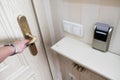 Female hand opening secure hotel door from inside. Closeup view of a security key card that controls power in a hotel room.