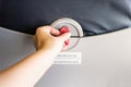 Female hand passenger opening airplane tray table on seat back for plane meal. Royalty Free Stock Photo