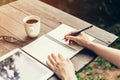 Female hand with pencil writing on notebook. Woman hand with pen Royalty Free Stock Photo