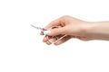 Female hand with perfect manicure holds nail scissors. Manicure scissors isolated on a white background Royalty Free Stock Photo