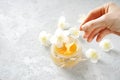 Female hand picks honey with a special cosmetic spoon